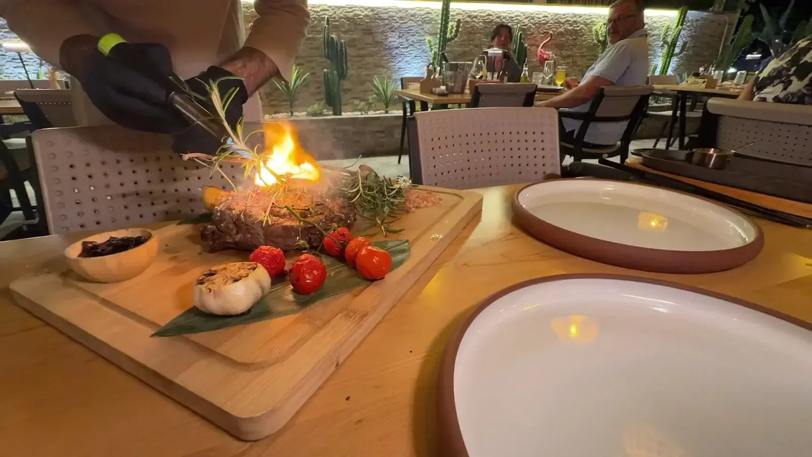 Beachfront tables at dusk at Cibo Mare e Terra restaurant in Himara