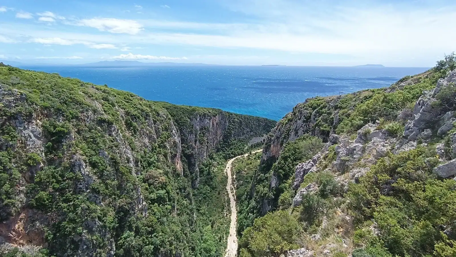 Narrow canyon trail leading to Gjipe Beach on the Albanian Riviera