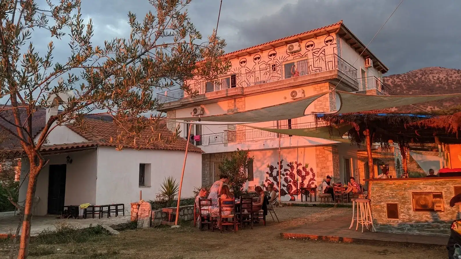Bright dormitory with bunk beds and lockers at Natural Hostel in Himara