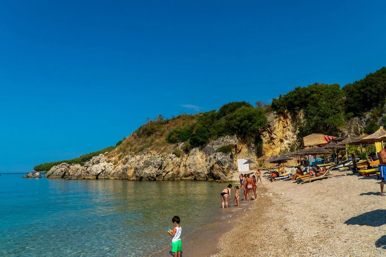 Rescue @ The Beach bar's covered seating with high tables on Himara beach overlooking the bay