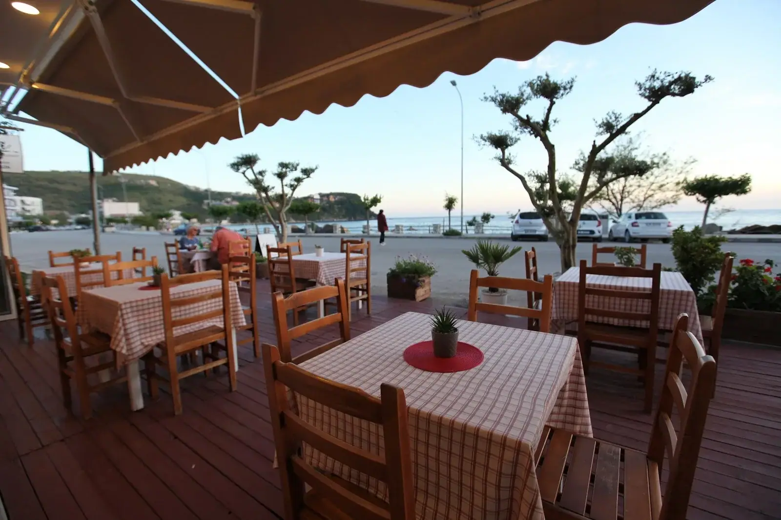 Sea-view terrace with wooden tables at Restaurant Kolagji in Himara