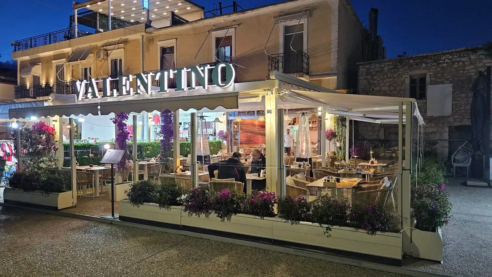 Valentino Restaurant outdoor terrace at night in Himara
