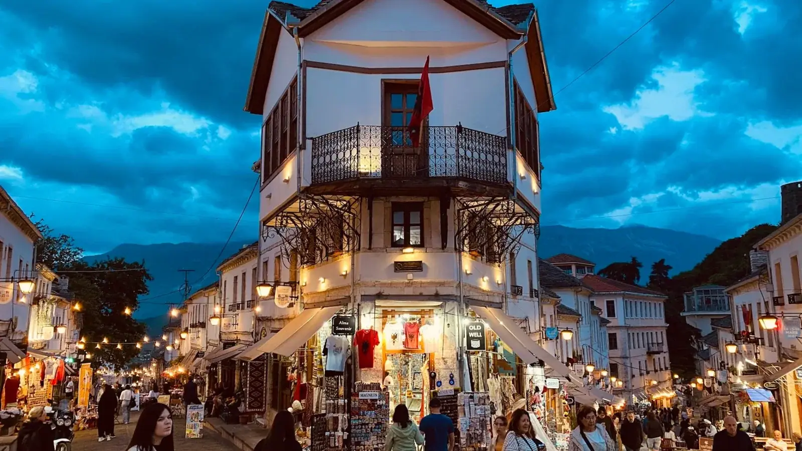 Gjirokastër's grey stone Ottoman houses and slate roofs climbing the hillside below the castle