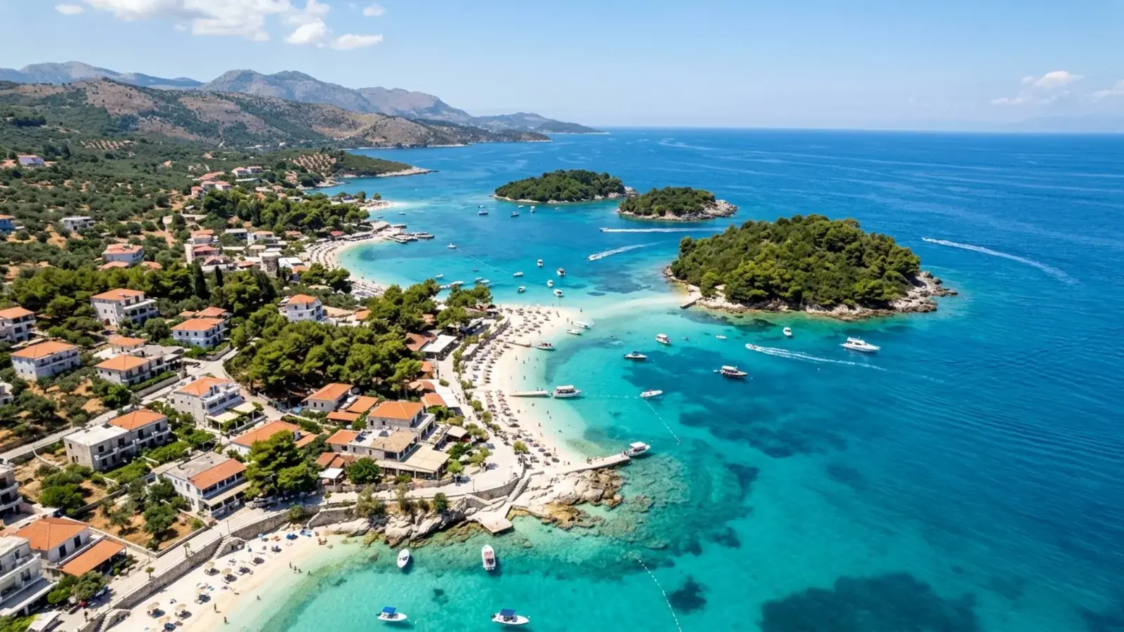 Ksamil's white sand and shallow turquoise bays with small wooded islets just offshore