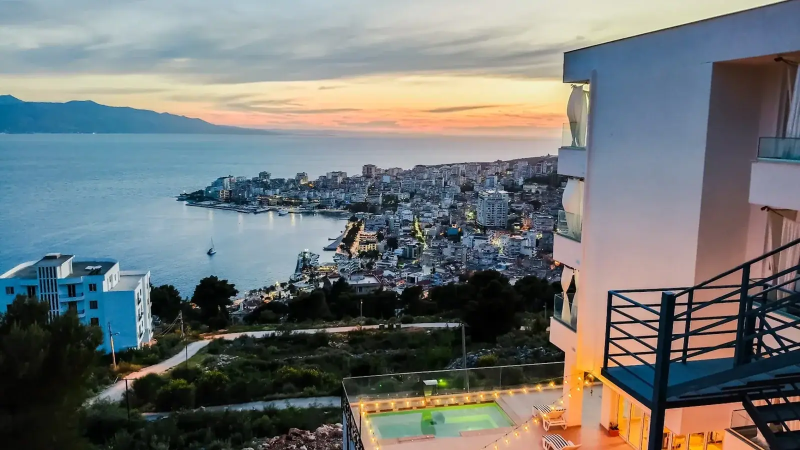 Saranda bay curving around the waterfront with the hillside town rising behind it