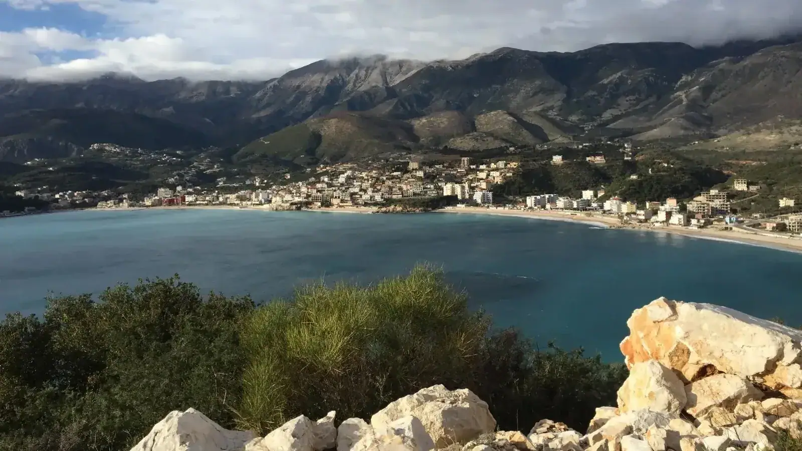 Himara town spread around its bay beneath the Ceraunian mountains