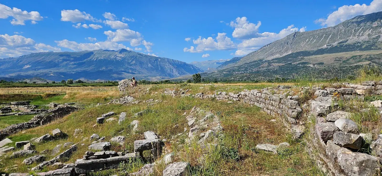 Panorama of the Hadrianopolis ruins across the Drino valley with mountains behind