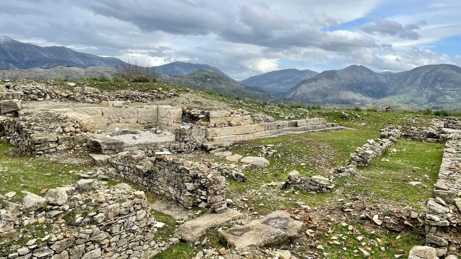 Ancient hilltop ruins and stone walls of Phoenice (Finiq) overlooking a green plain near Saranda