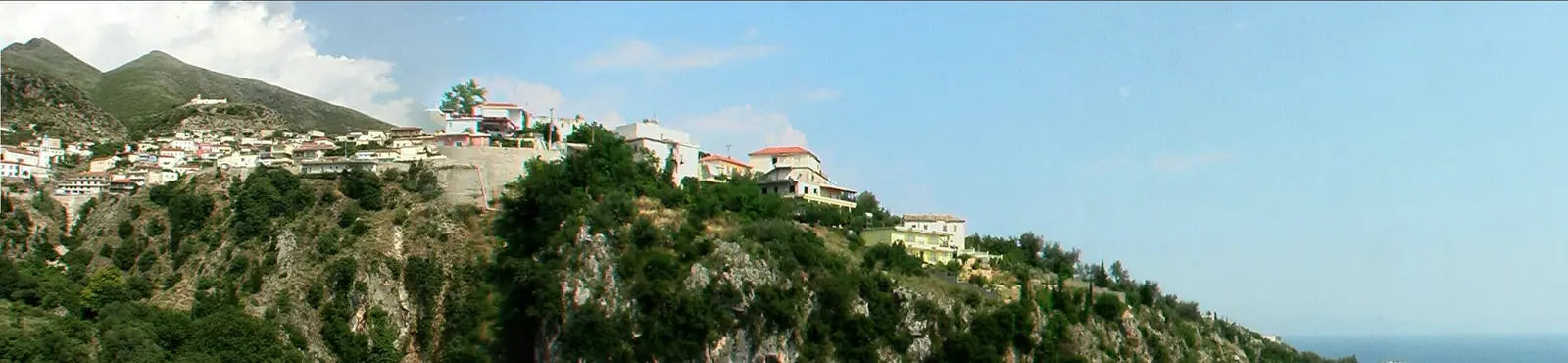 Dhermi village below and the hilltop where Panagia Drymadon monastery overlooks the Ionian coast