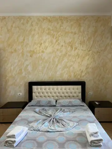 Standard Quadruple Room: the bed square-on, with a nightstand either side