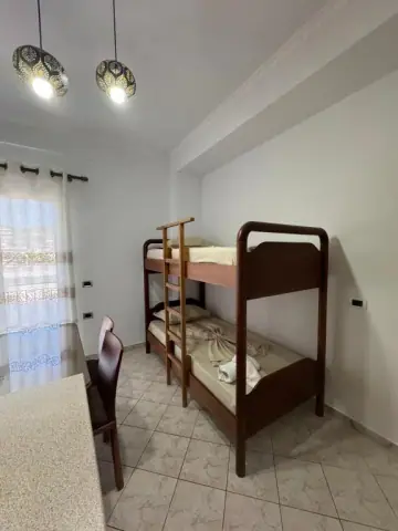 Family Suite: a timber bunk bed against the wall, with a table and chair by the window