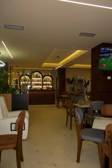The dining room at Hotel Frida, tables and chairs running back towards the bar