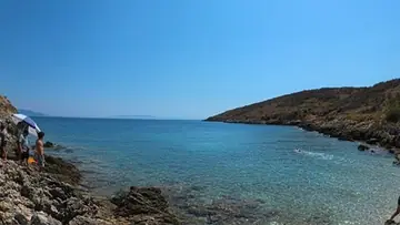 Swimmers along the rocky shore at Jale Beach