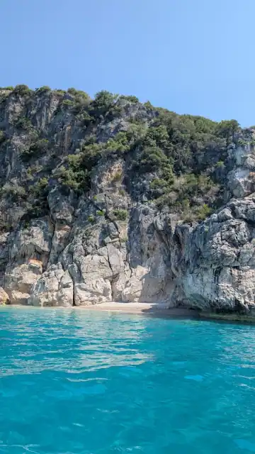 Limestone cliffs enclosing the turquoise cove at Couple's Bay