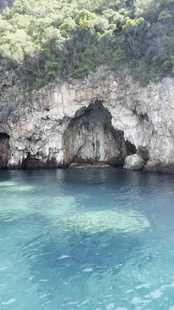 Sea cave arch above turquoise water at the Monastery Caves