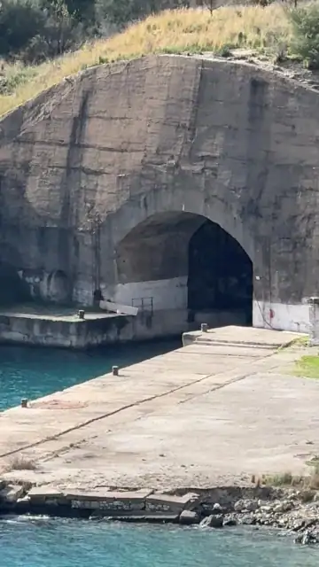The submarine tunnel mouth and its concrete apron above turquoise water