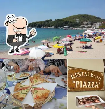 Seafront dining terrace with set tables overlooking the bay at Piazza Restaurant in Himara