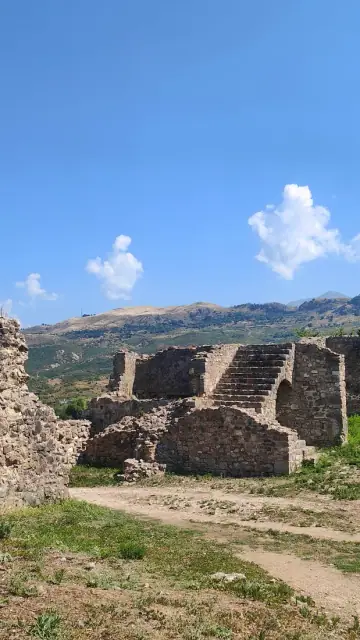 Stone ruins of the monastic complex at Mesopotam with hills behind