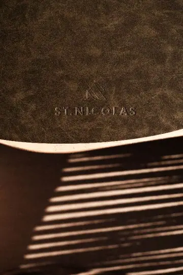 A menu folder embossed ST. NICOLAS, in raking light