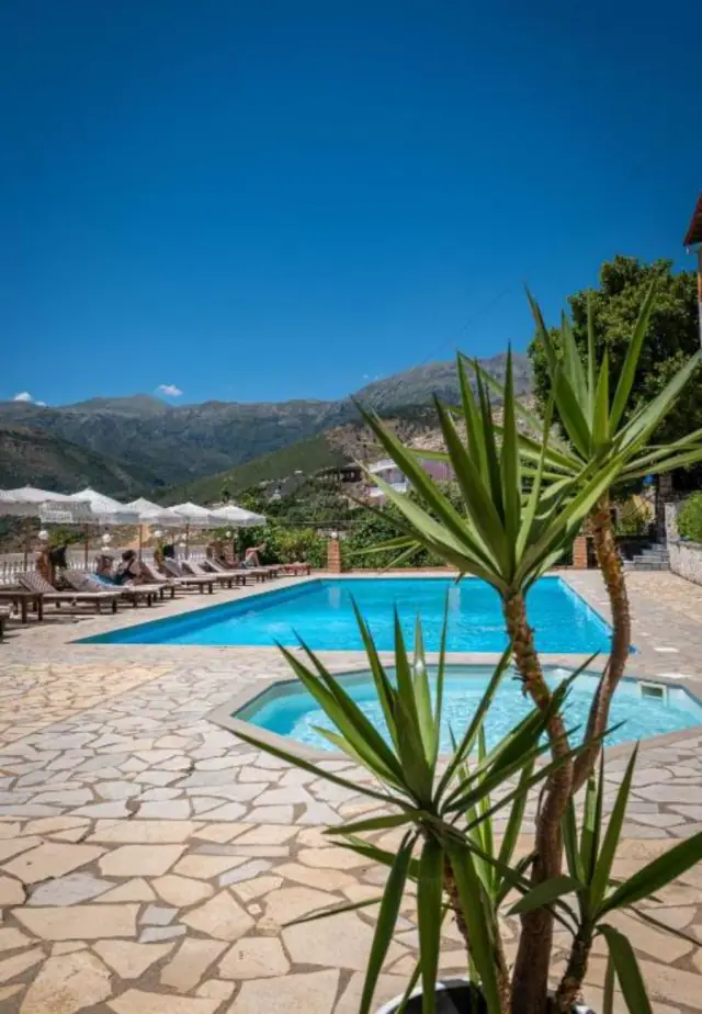 The children's pool in the foreground with a yucca beside it, the long pool behind and the mountains across the valley