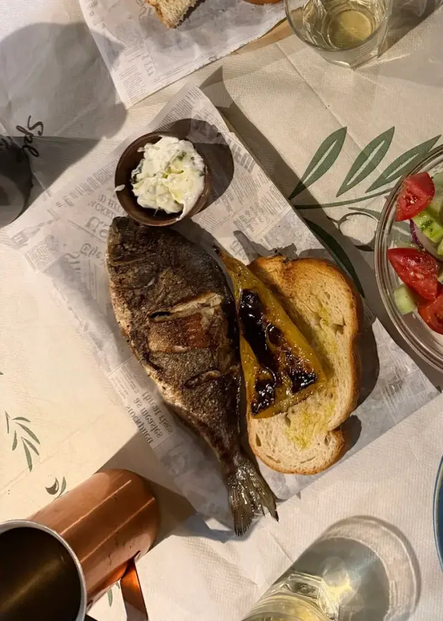 A whole sea bream with toasted bread, a pot of white dip and a Greek salad at Bar 300