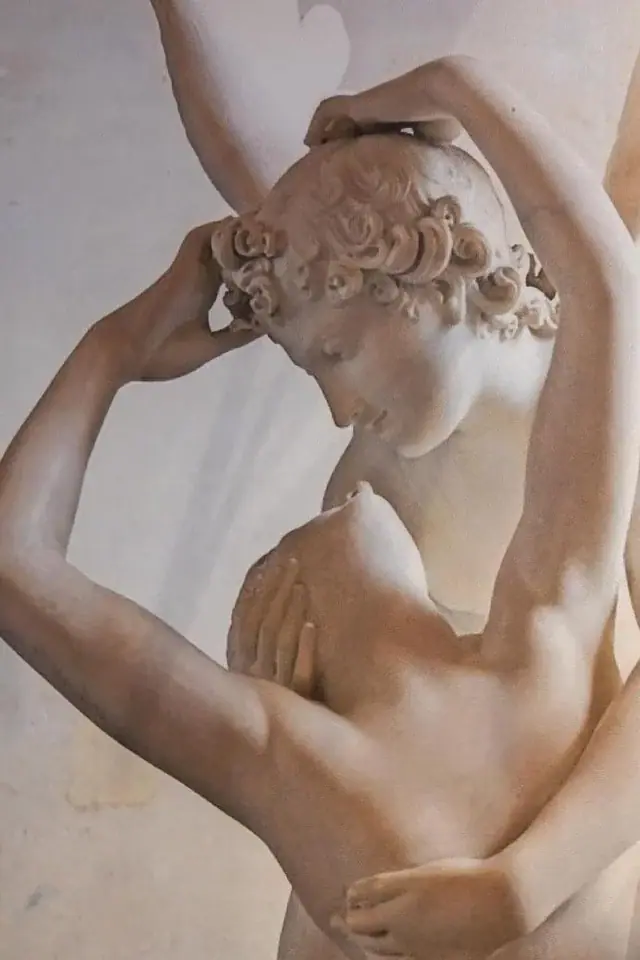A full-height mural in a room at Dimitri Hotel reproducing Canova's Psyche Revived by Cupid's Kiss, her head tipped back into his arms