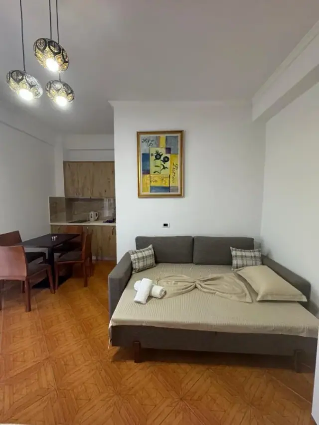 Triple Room: the sofa, the dining table and the kitchen units with a kettle