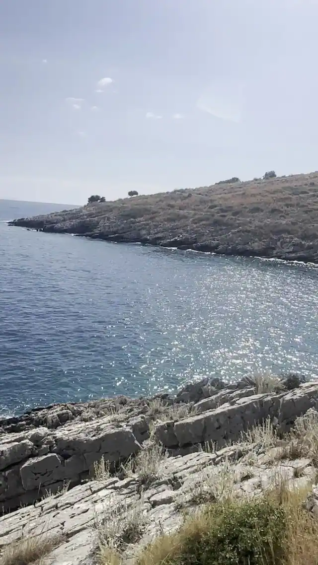 Rock shelves and open sea at Andreas Beach, looking out past the headland south of Himara