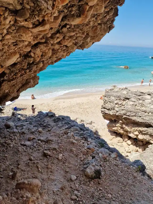 Palasa Beach framed by an overhanging rock ledge