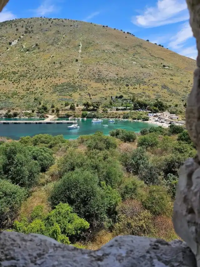 Green slopes above the moorings in Porto Palermo bay