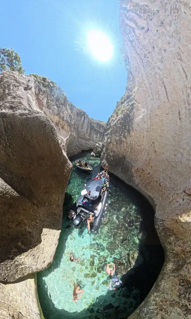 A boat threading the narrow cleft of Smuggler's Canyon