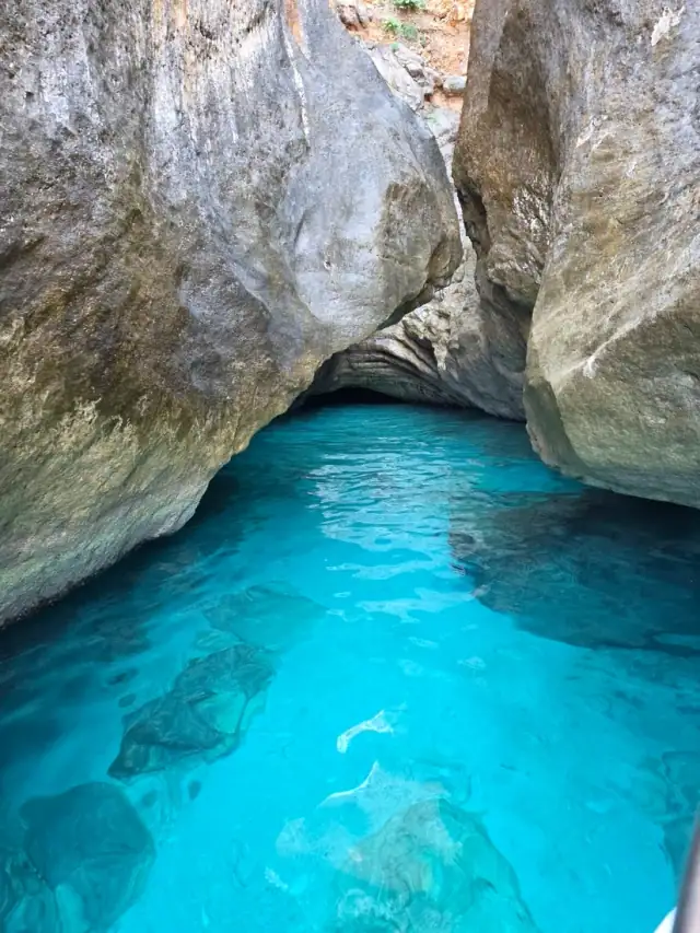 Glowing blue water under the roof of Thunder Cave