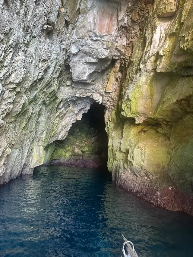 Exploring Himara Boat Trips vessel at a swimming stop on the Albanian Riviera coastline
