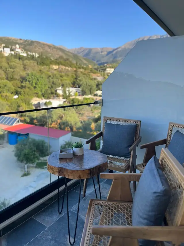 Garden Inn Himara terrace with mountain views over the valley