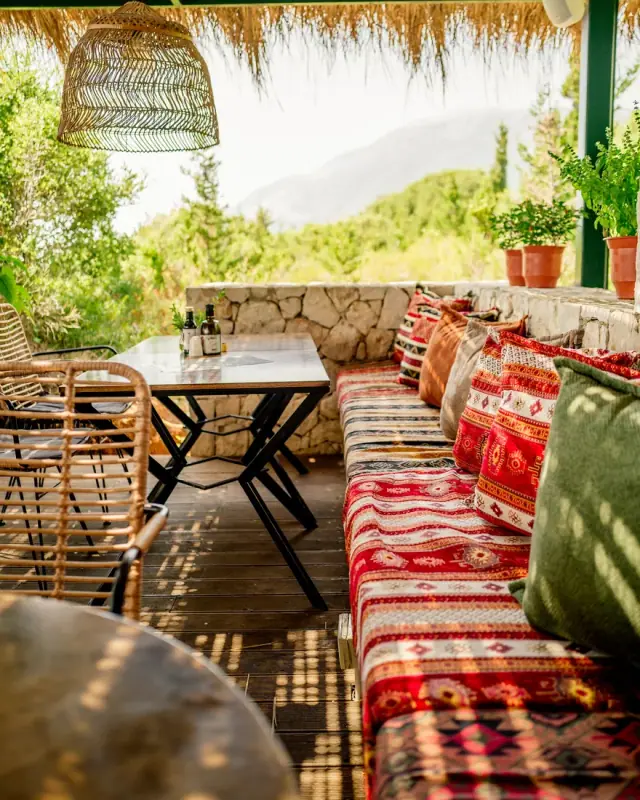 Boho terrace with kilim cushions and a mountain view at Morsi Drymades on Drymades Beach