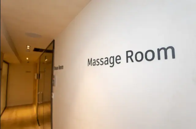 The Massage Room lettering on the spa corridor wall