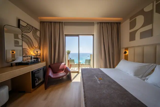 A Double Room with Sea View, the balcony door open onto the water